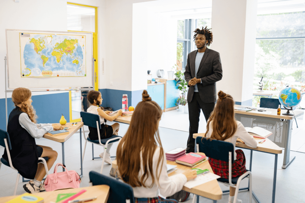 Teacher leading geography lesson in bright classroom