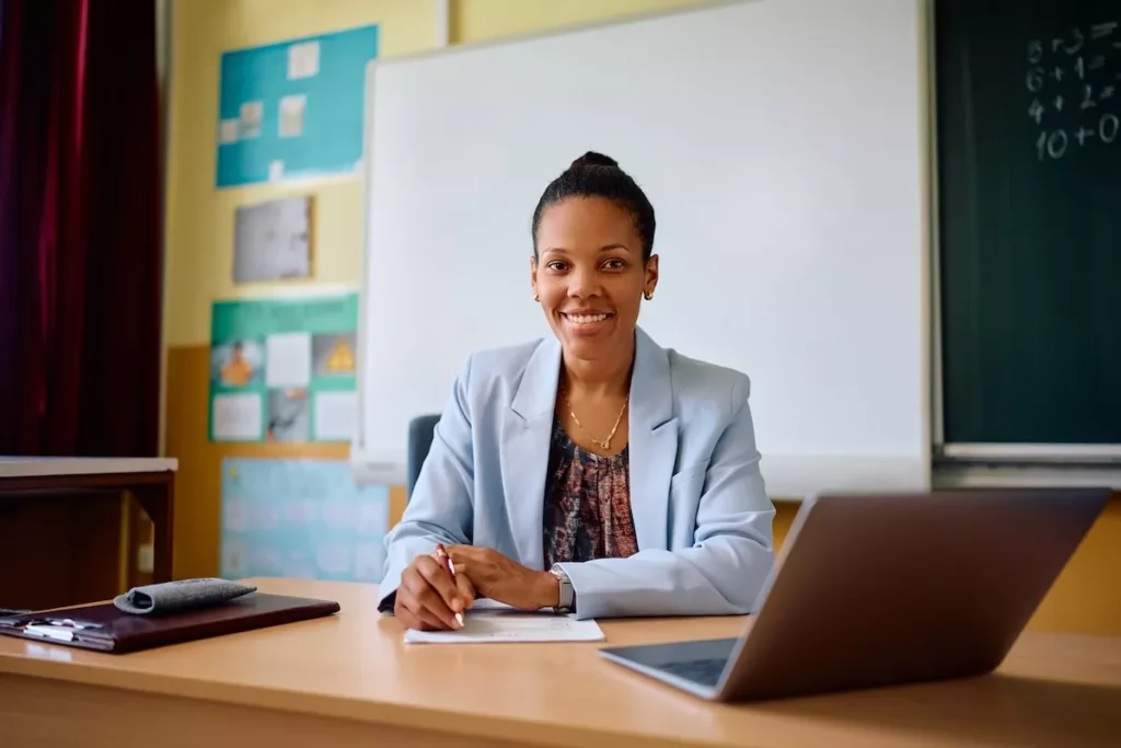 Smiling teacher at desk in classroom