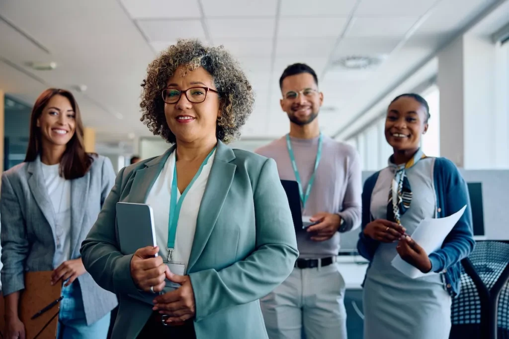Diverse office team smiling in modern workplace